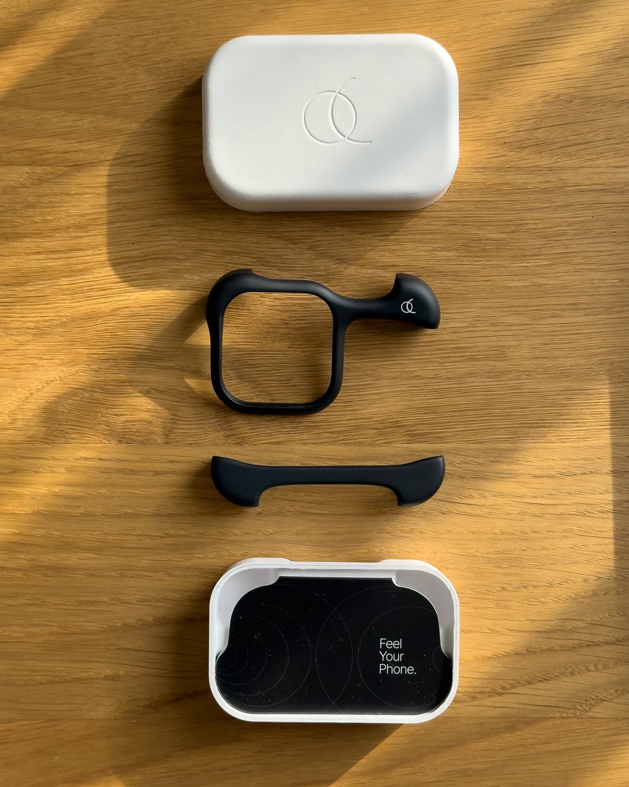 The two Arc Pulse shells laid out between the lid and base of their box - Luxe Digital