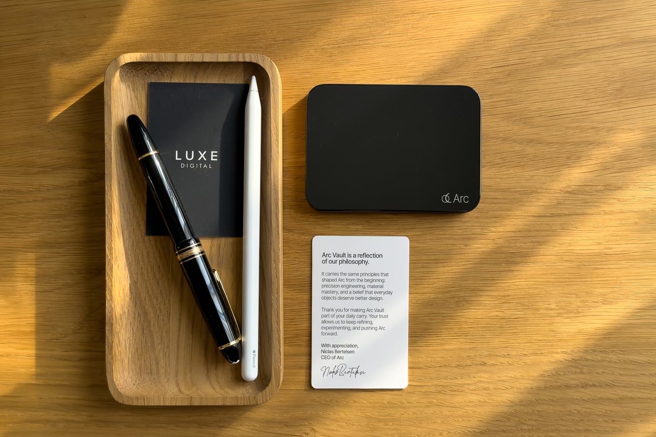 Arc Vault in Onyx Black beside a printed note from Arc and a wooden pen tray - Luxe Digital