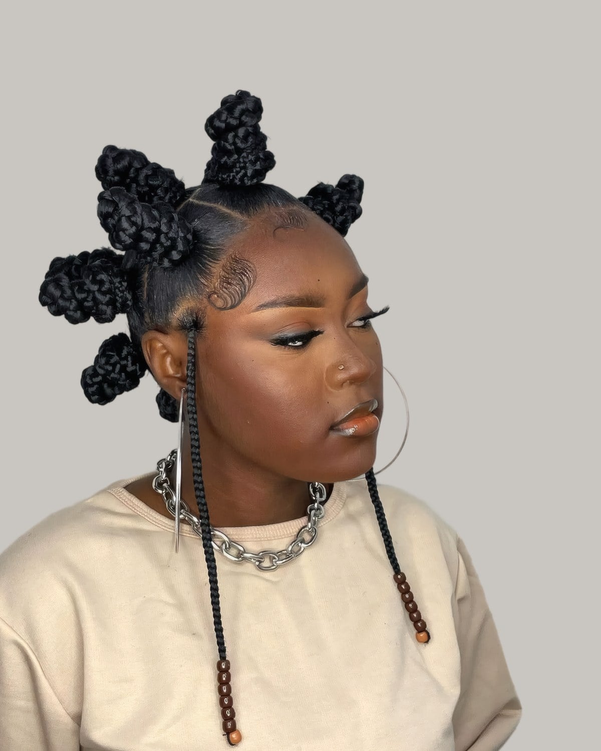 Woman with large braided Bantu knots and long braids at the front