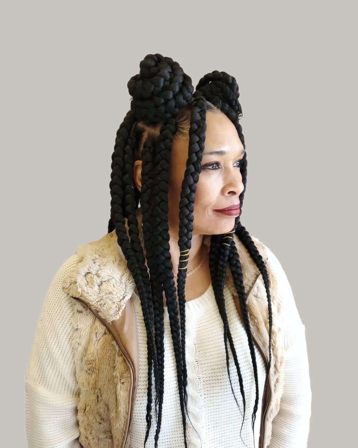 Woman with long black braids wound into two buns on top