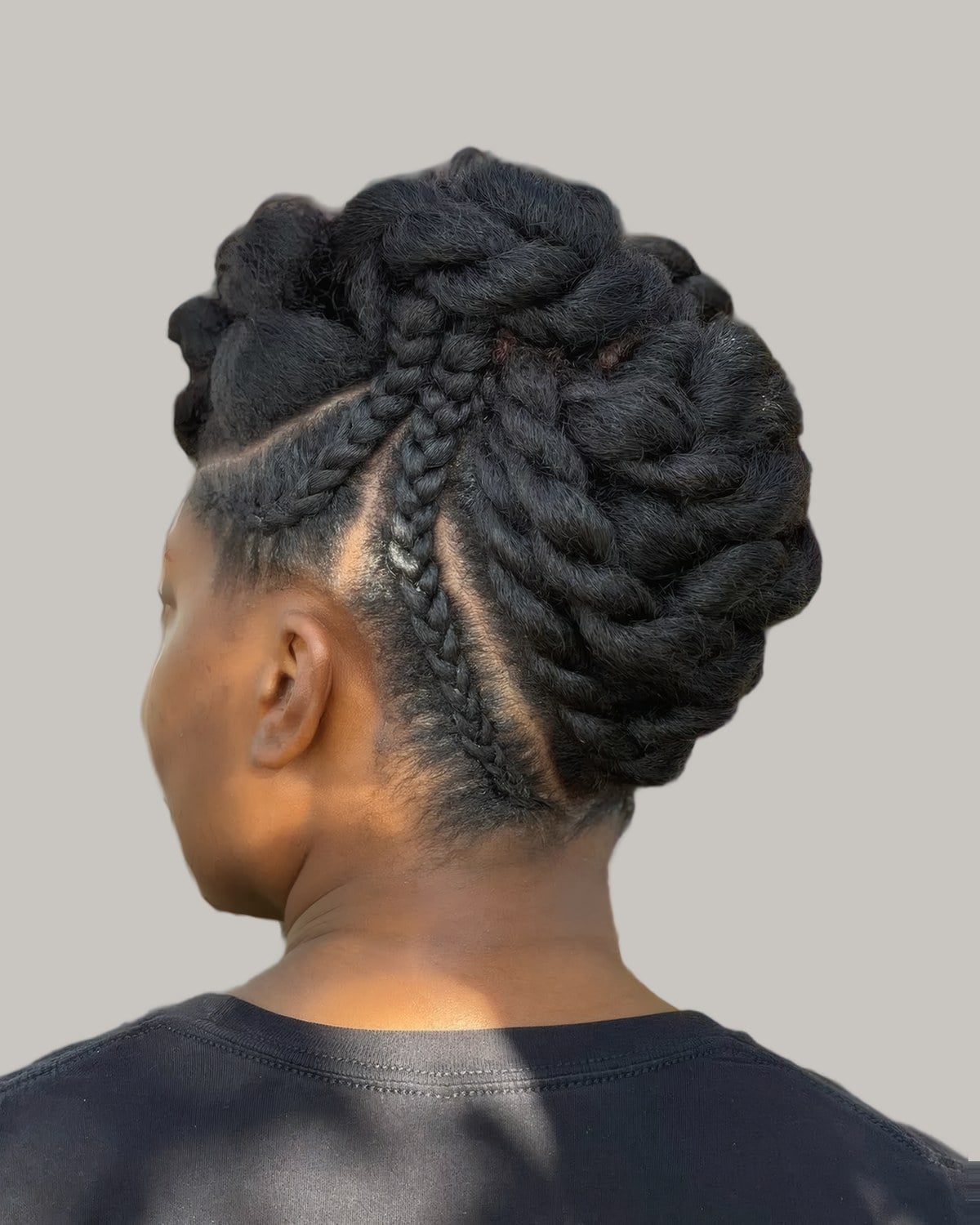 Back view of chunky twists pinned into an updo with braided sides