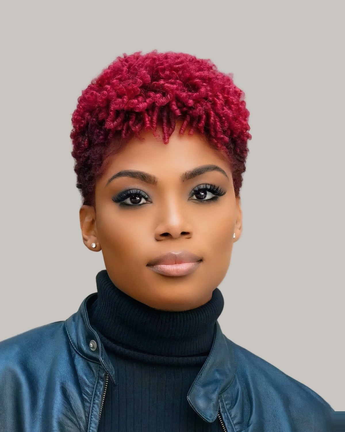 Woman in a leather jacket with a short red tapered afro