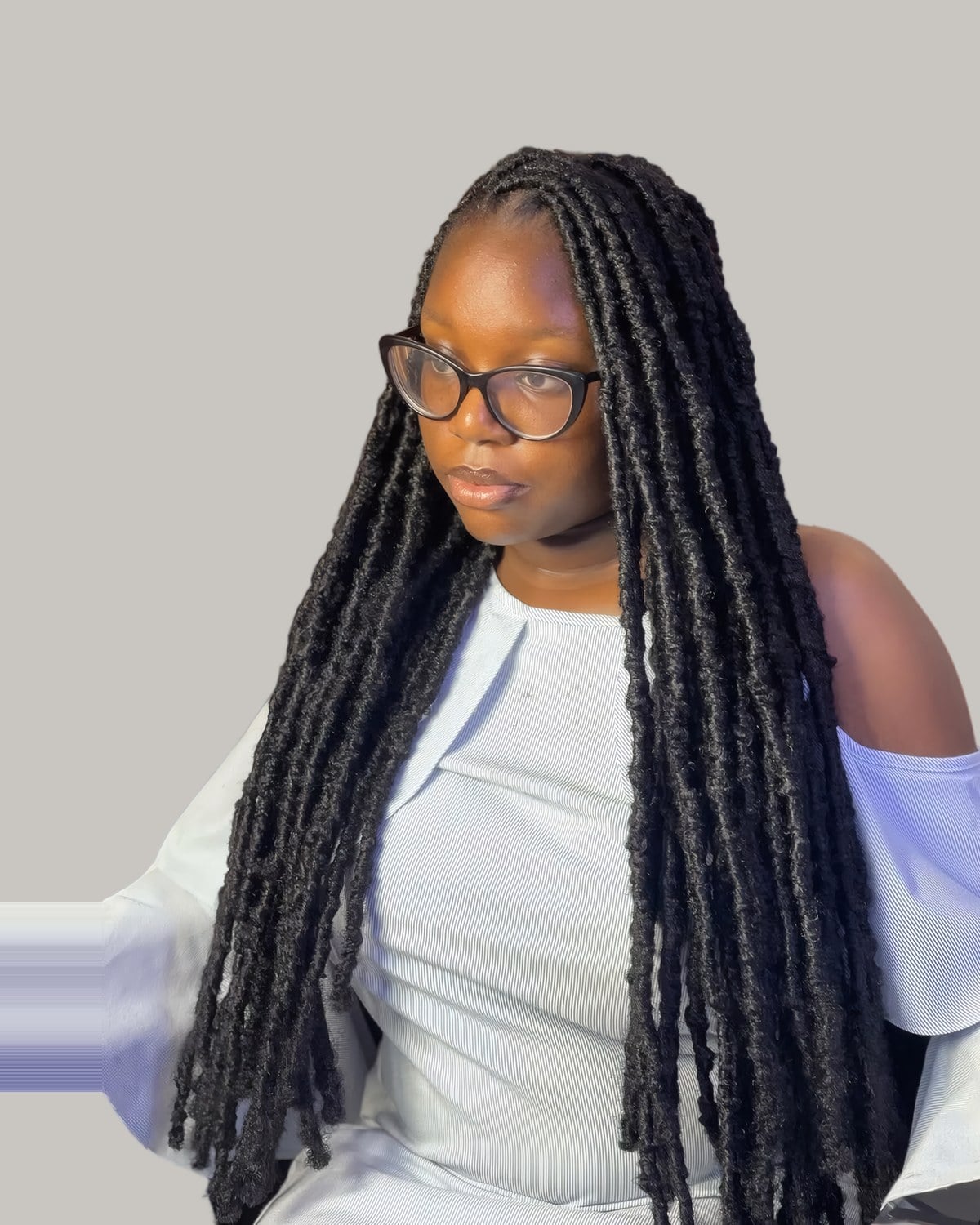 Woman in glasses with long jumbo braids and square parts