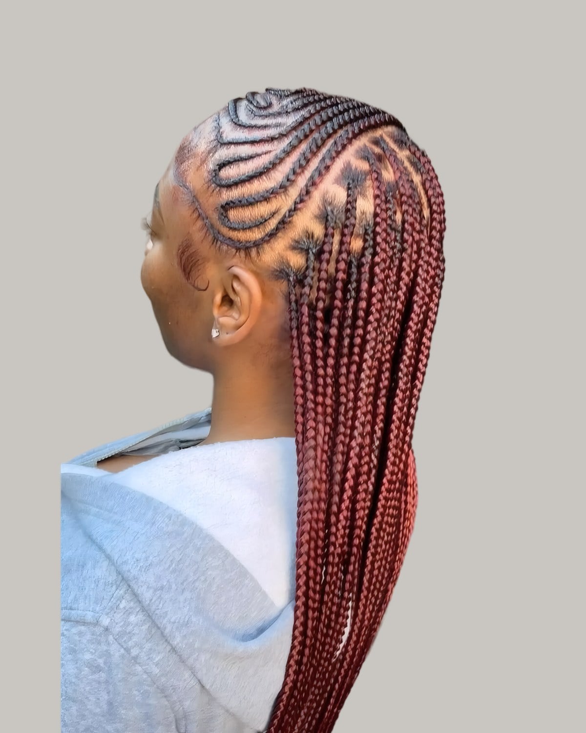 Woman seen from behind with cornrows on top and red braids below