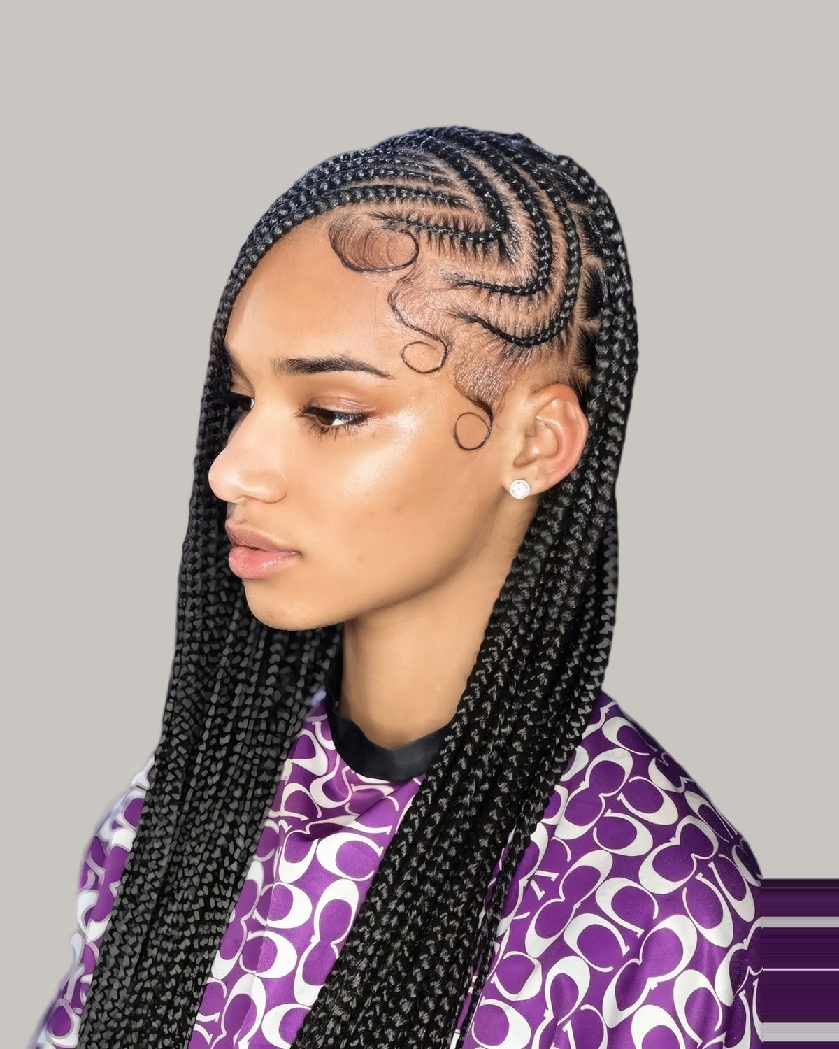 Woman in profile with curved cornrows and long braids