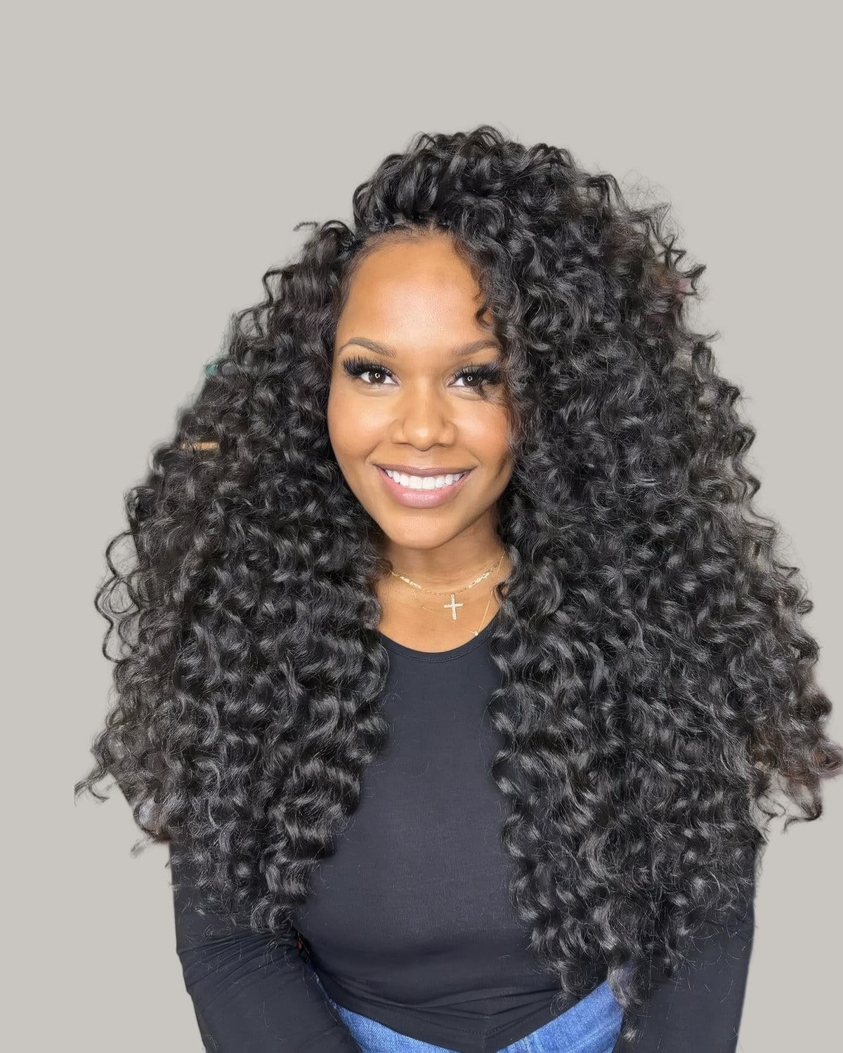 Smiling woman with long crochet curls past her shoulders