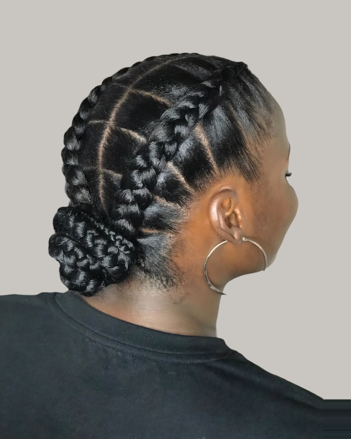 Back view of cornrows braided into a low bun at the nape