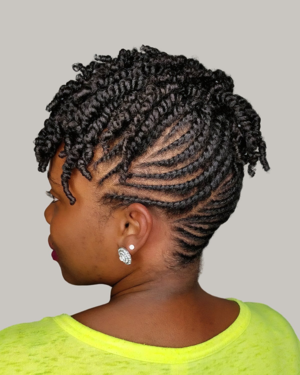 Woman seen from the side with flat twists and a twist-out on top