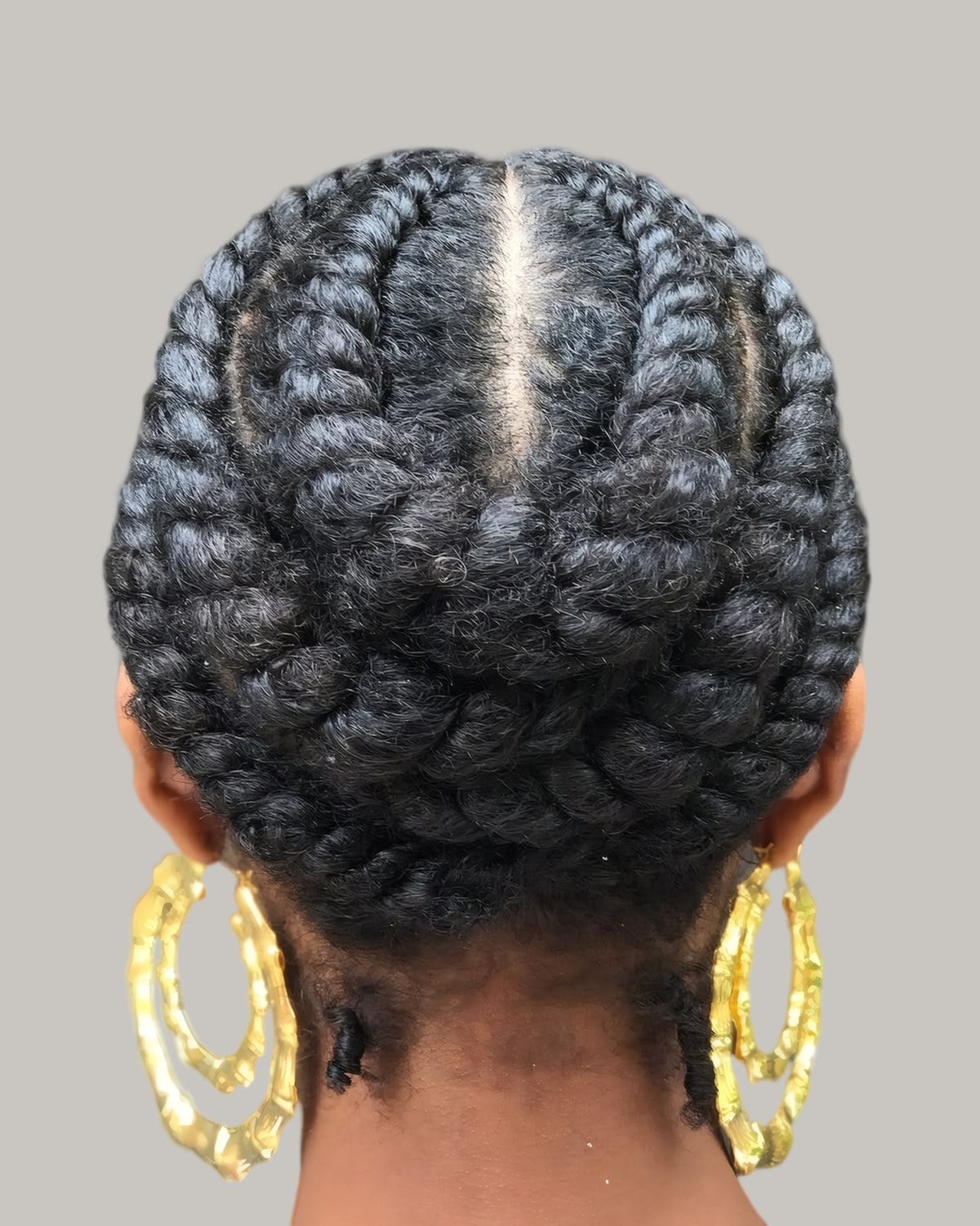 Back view of flat twists wrapped around the head into a low updo