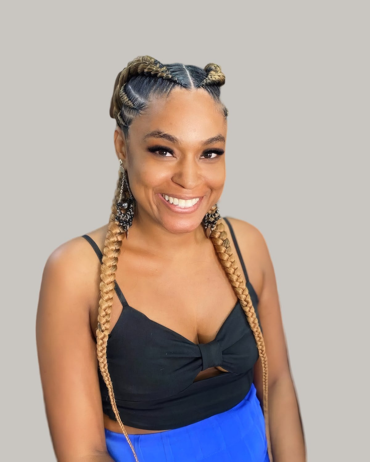 Smiling woman with two long blonde feed-in braids