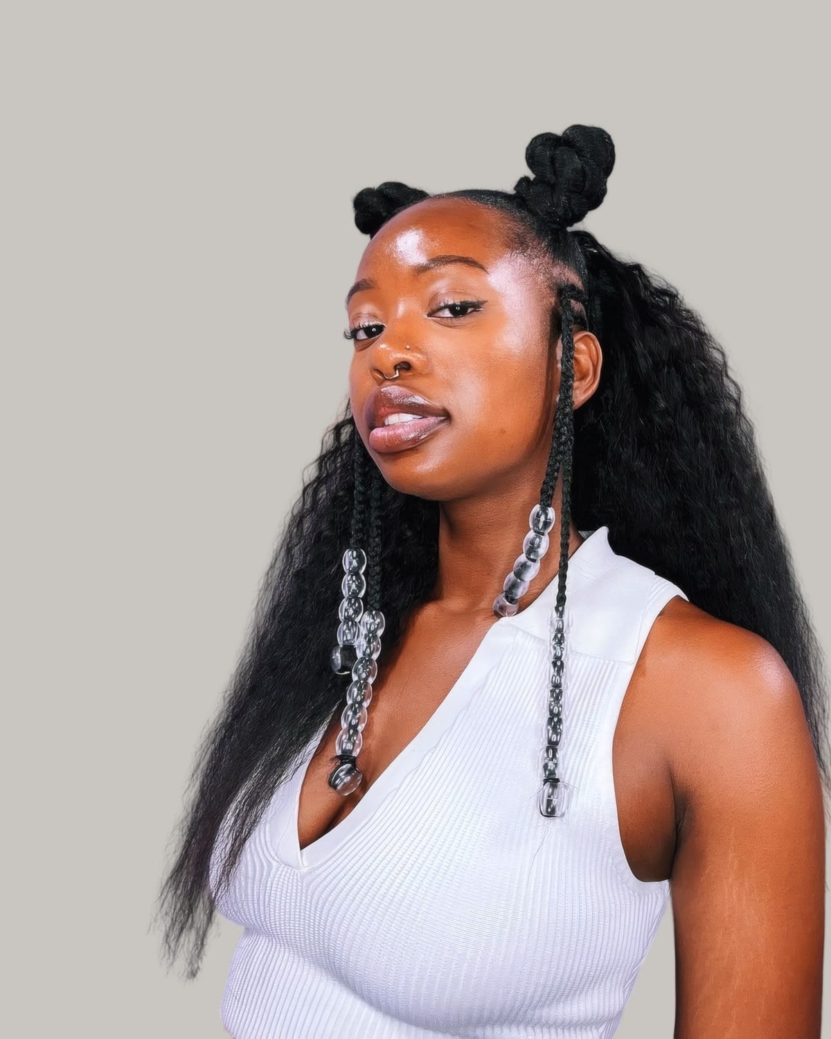 Woman with two small buns on top and long crimped hair falling below