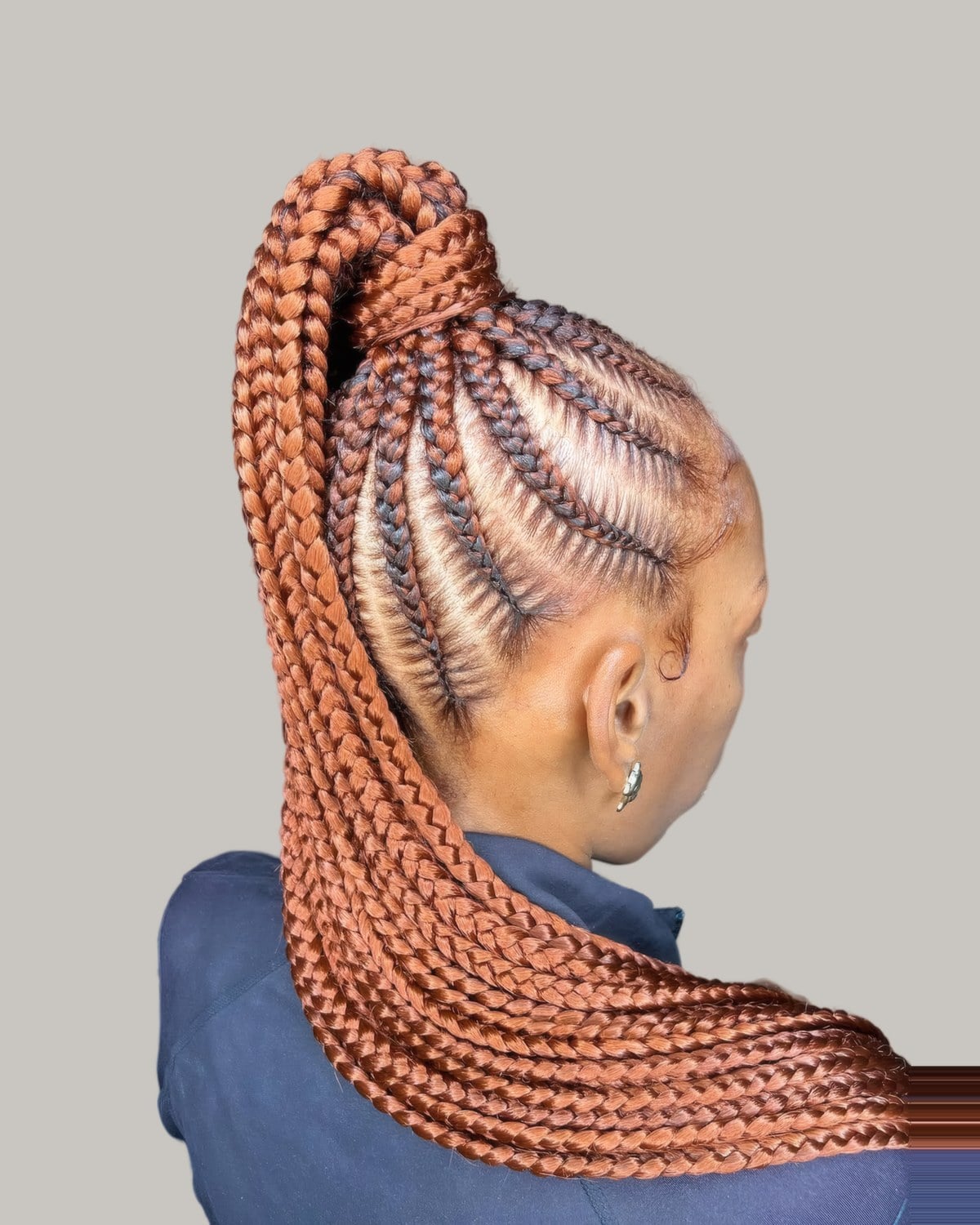 Woman seen from the side with copper feed-in braids in a high ponytail