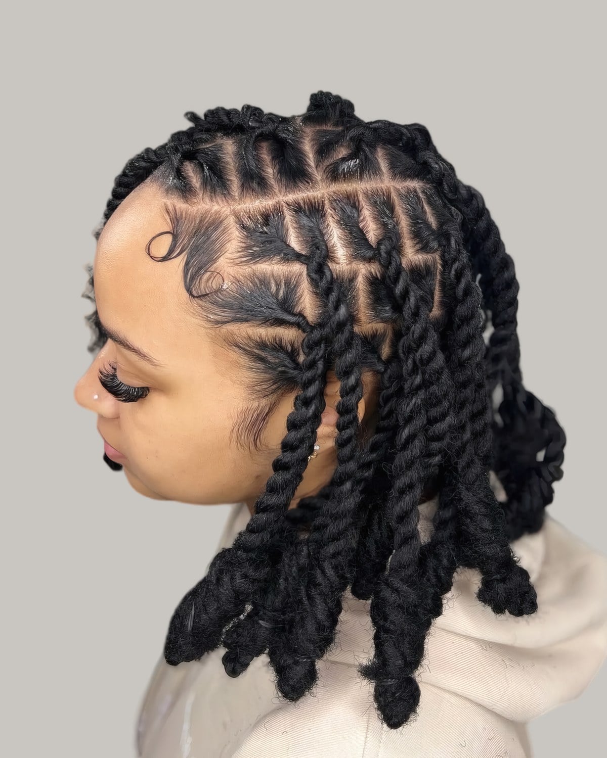 Woman in profile with short two-strand starter locs