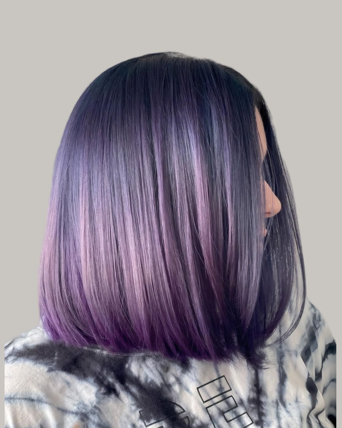 Sleek black bob fading to purple, seen from behind