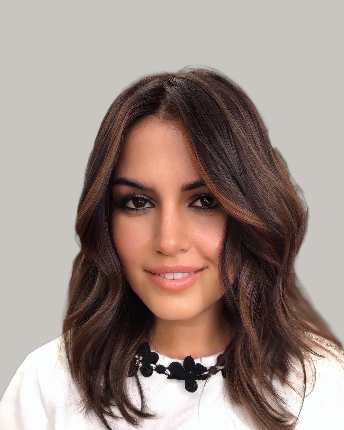 Smiling woman with shoulder-length dark brown waves and lighter chocolate ends