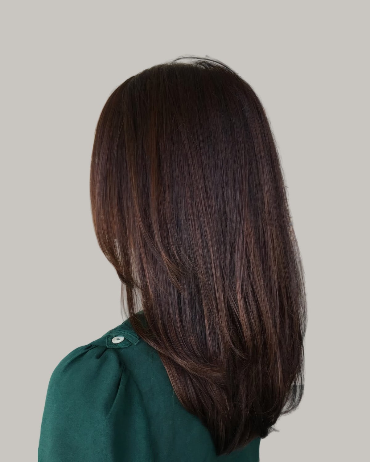 Side view of sleek, straight dark brown hair past the shoulders