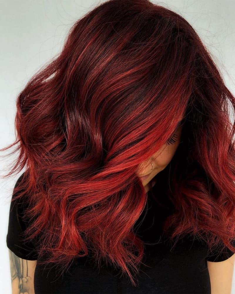black hair highlights fiery red highlights on jet black base - Luxe Digital
