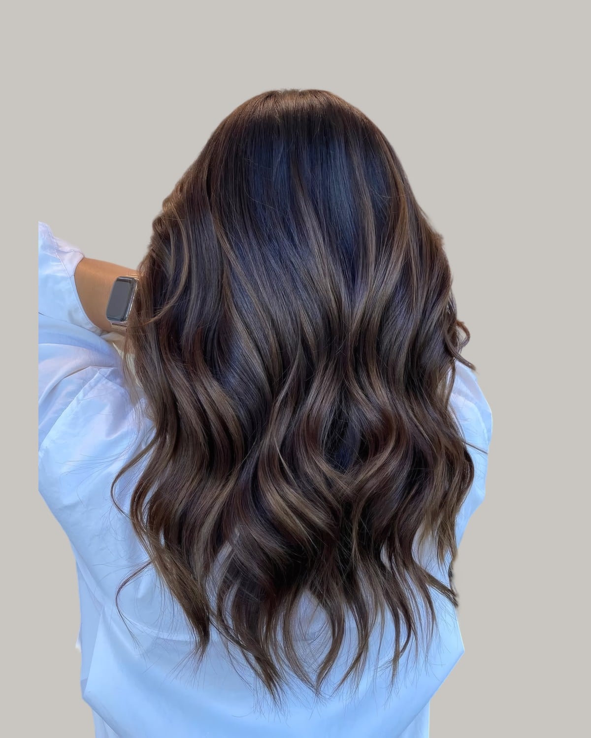 Back view of long dark brown waves with soft brown highlights
