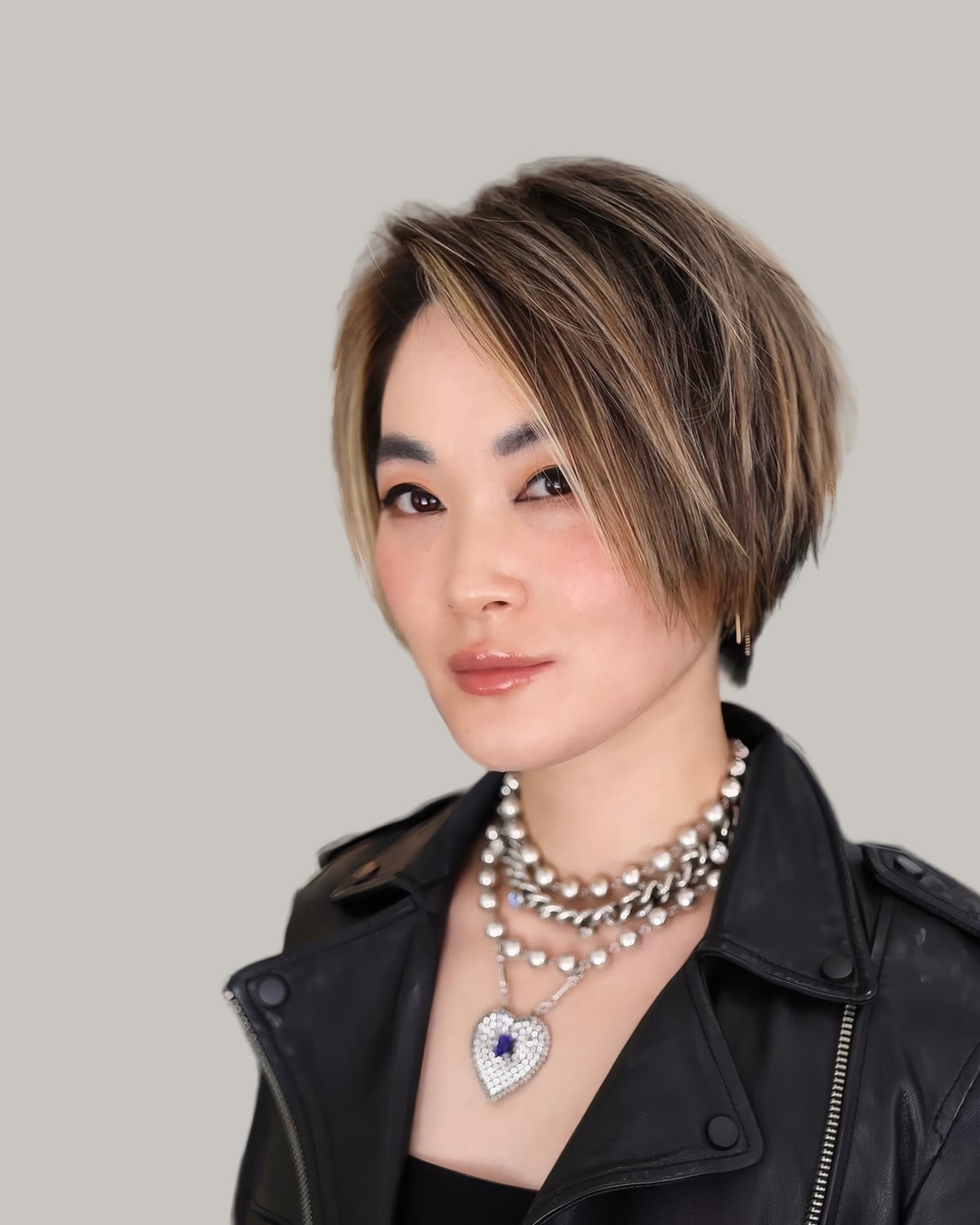 Woman with a dark bob and brown highlights