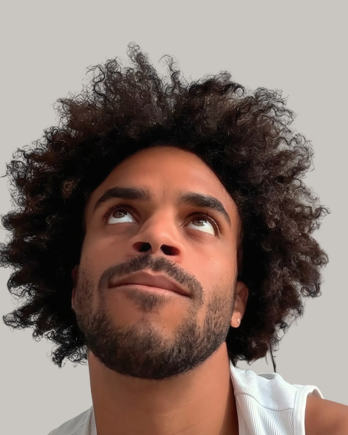 Bearded man with a big curly afro, looking up