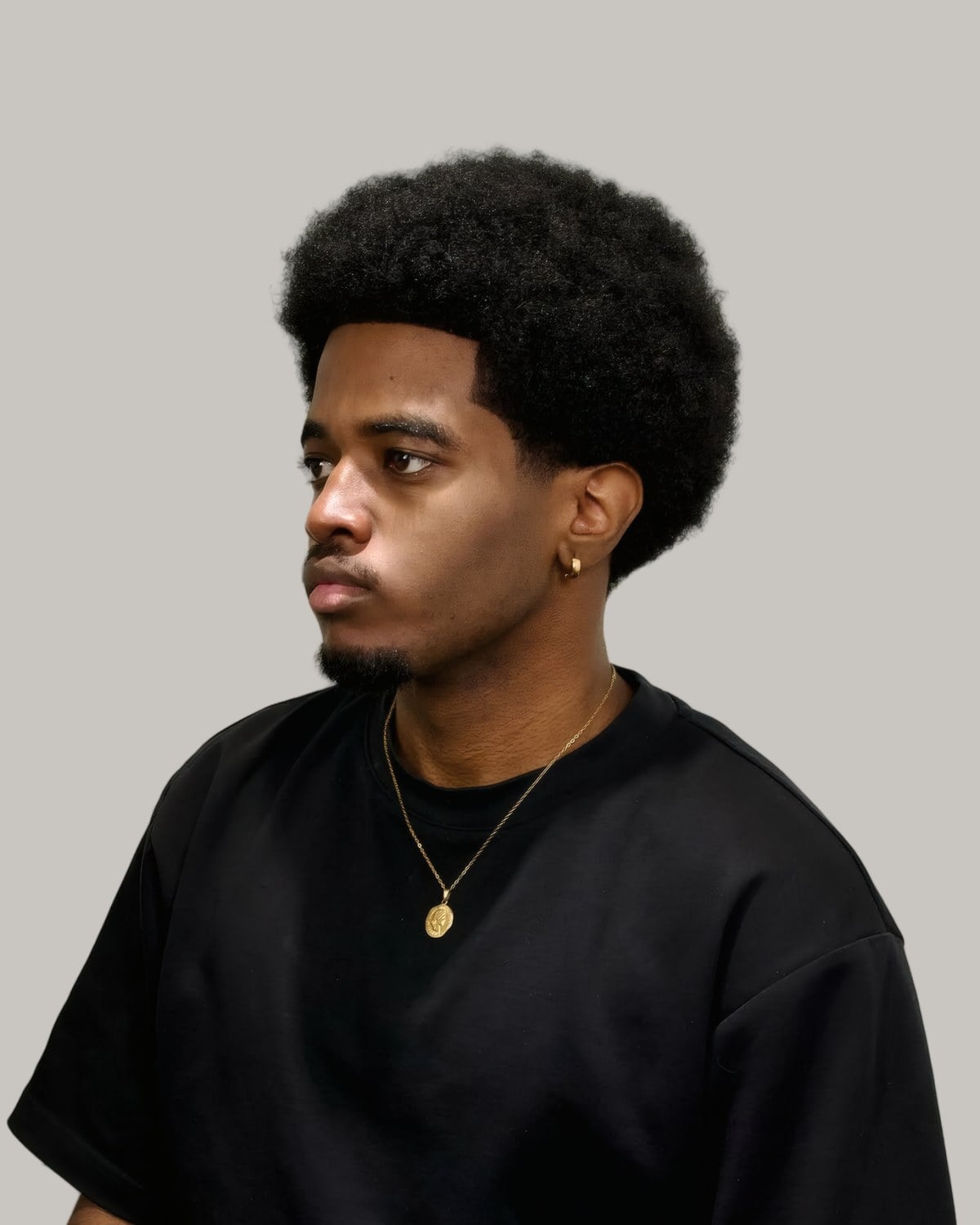 Man with a big rounded afro, seen at an angle