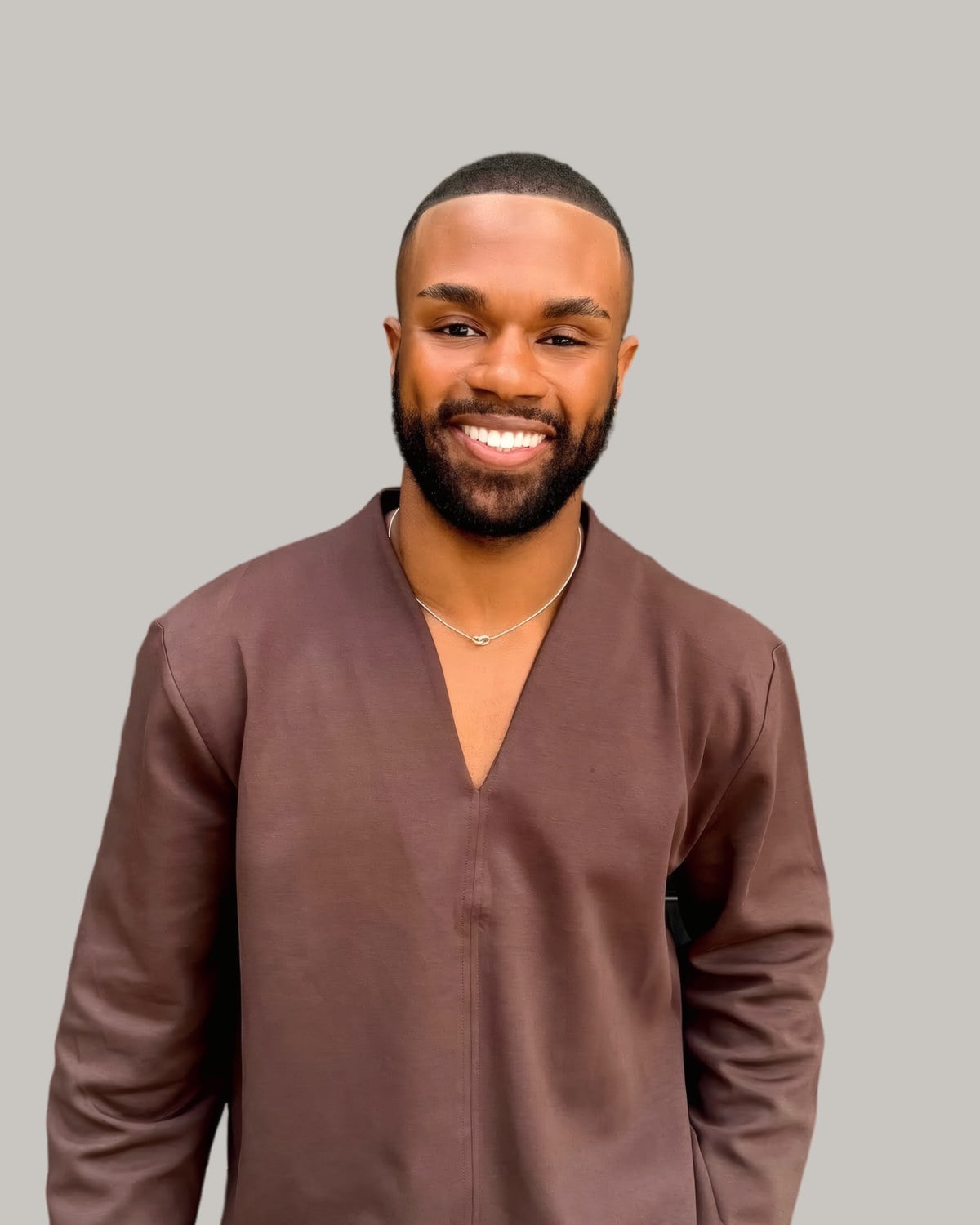 Smiling man with a buzz cut and a beard, seen from the front