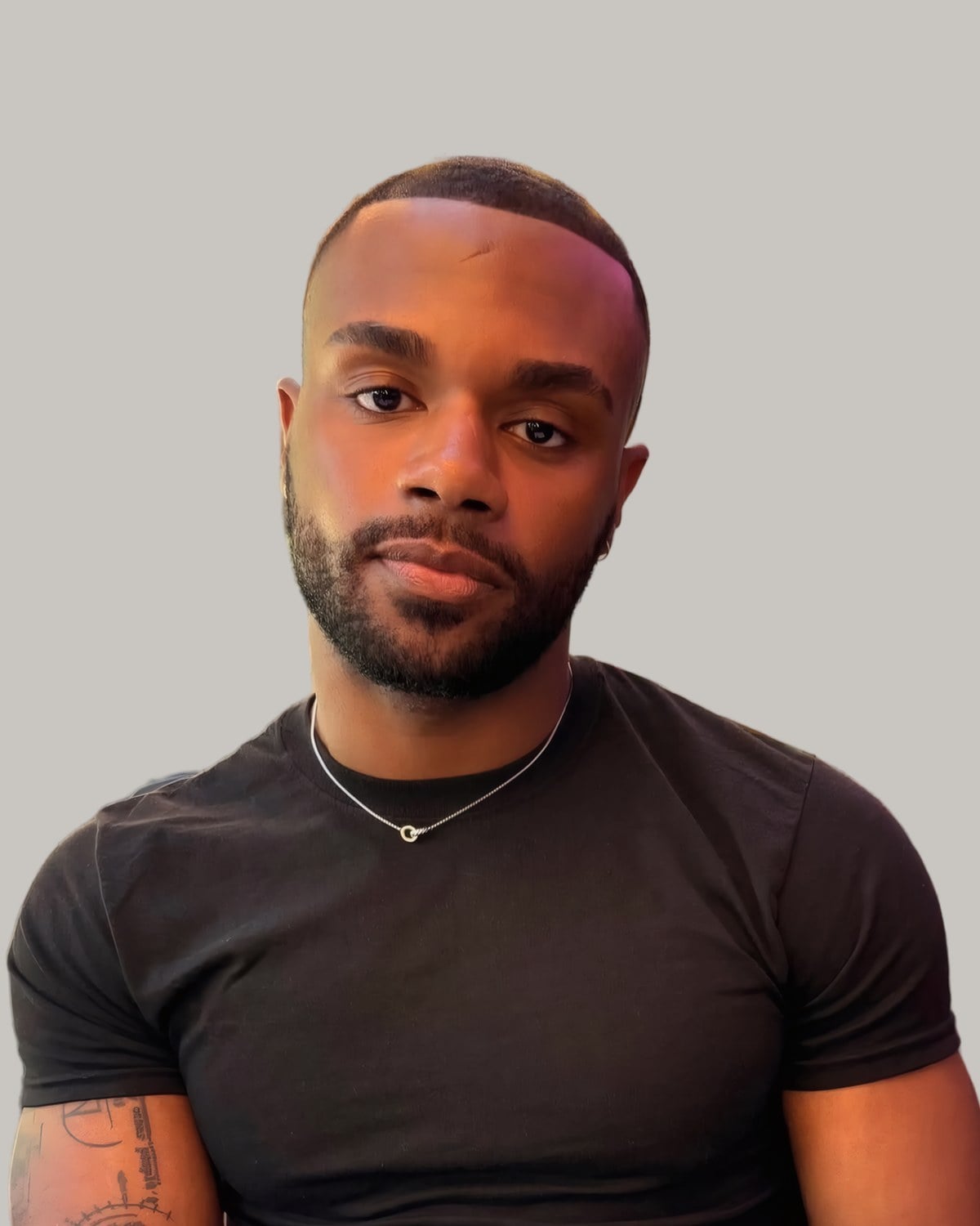 Man with a short buzz cut and a beard, seen from the front