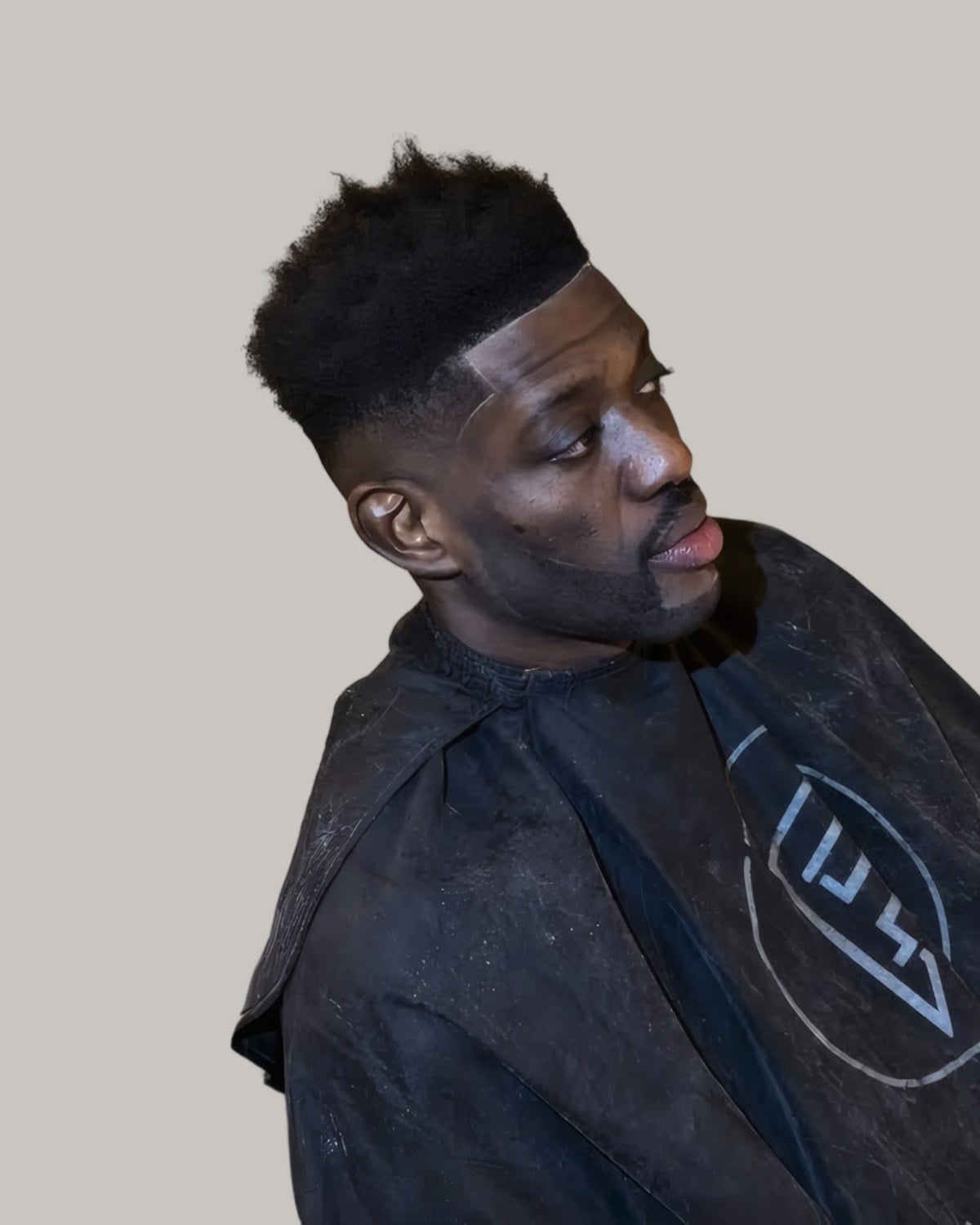 Man with a high top fade, seen at an angle