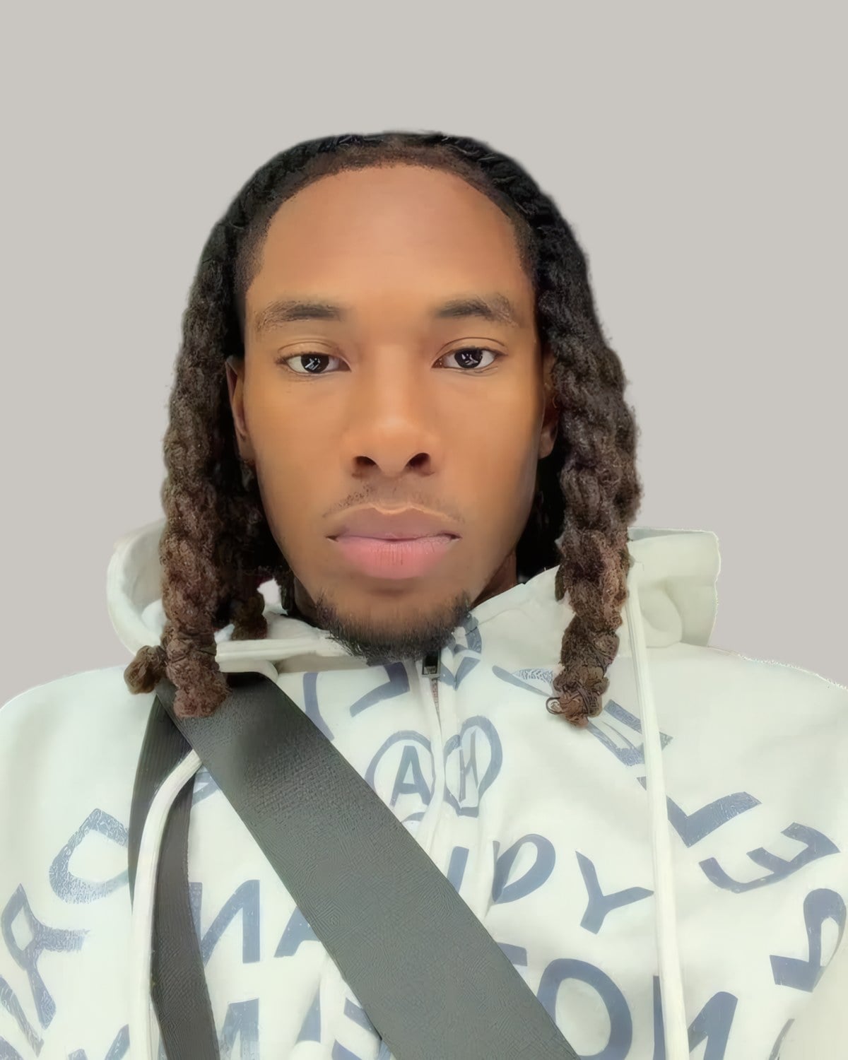Man with long locs and a light beard, seen from the front