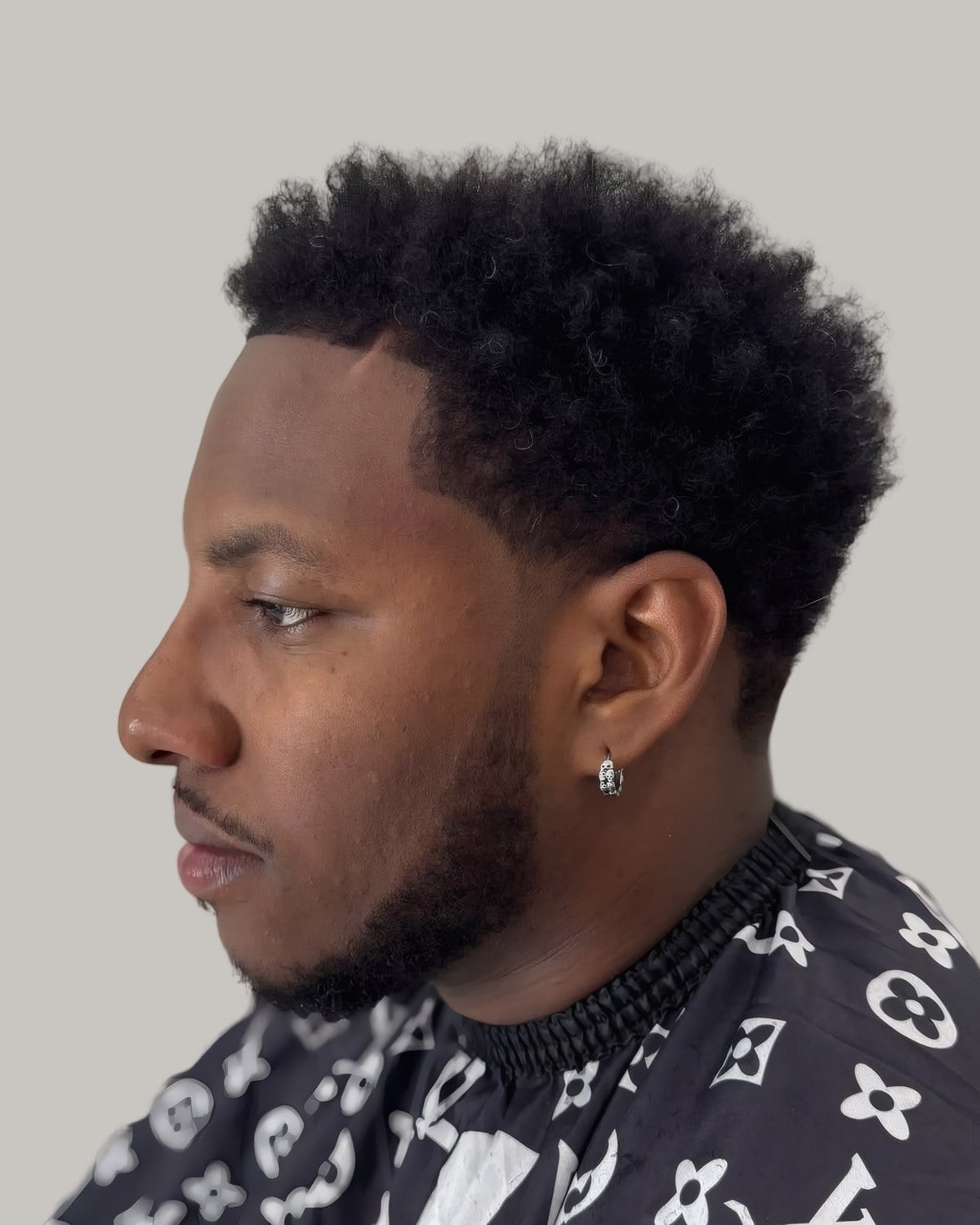 Bearded man with sponge twists and a taper, seen in profile