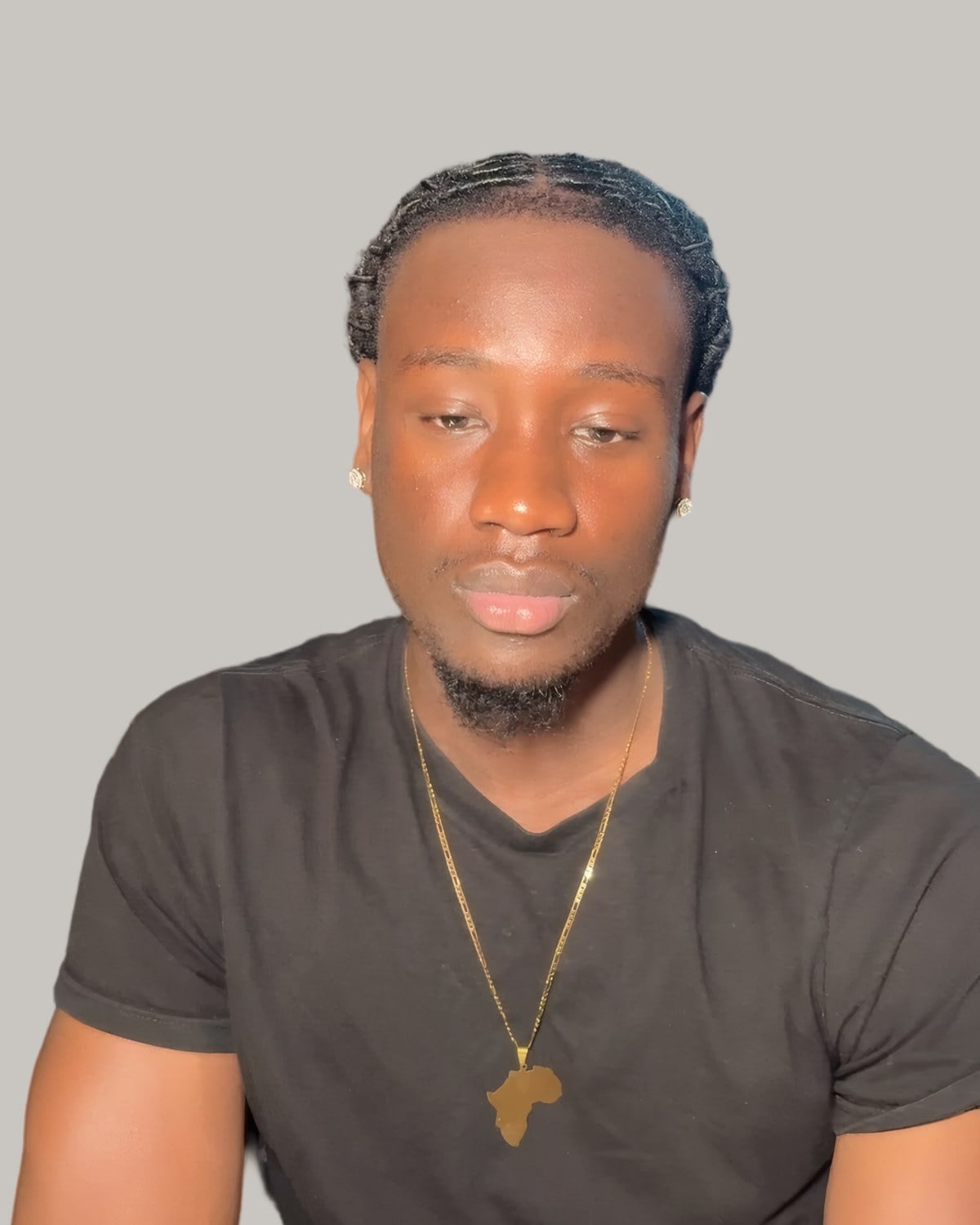 Man with short starter locs, seen from the front