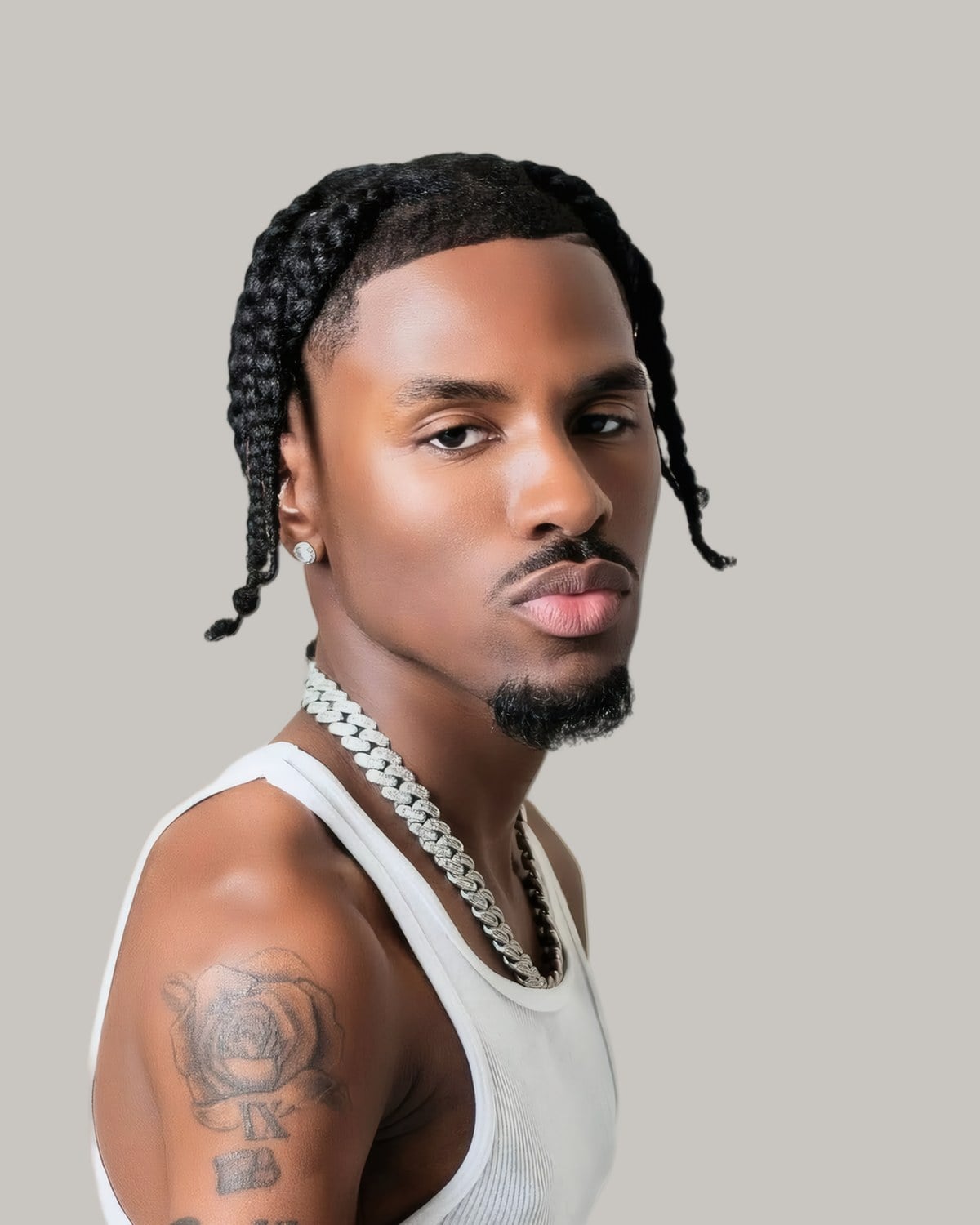 Man with two braids, one down each side, seen at an angle