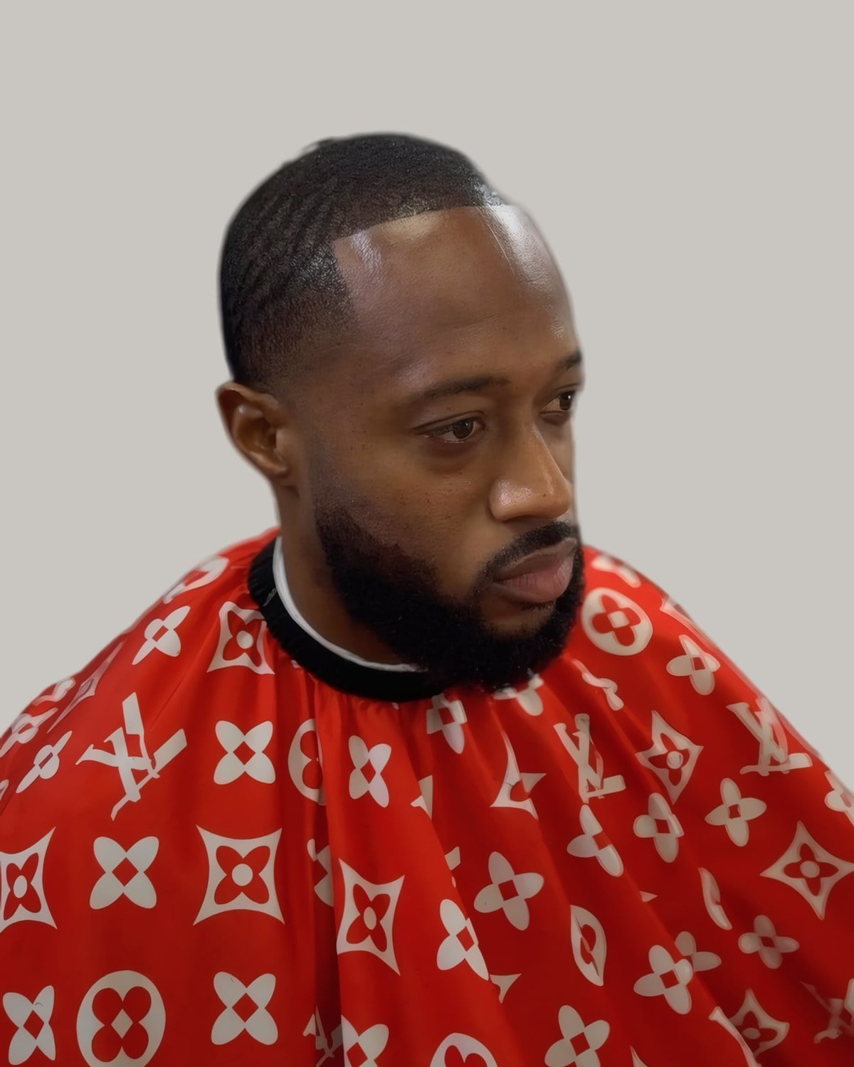 Man with brushed waves and a full beard, seen at an angle