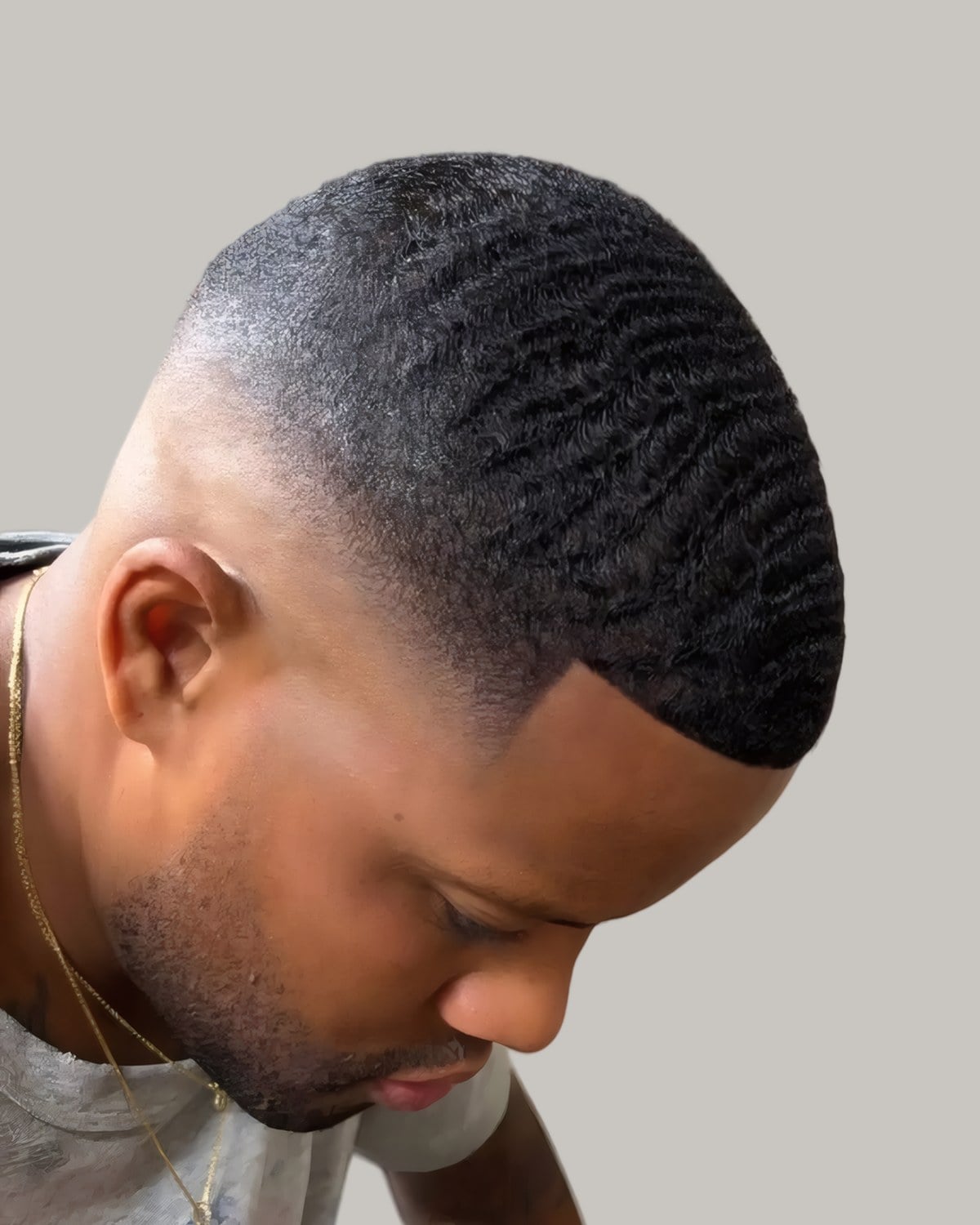 Bearded man with waves and a sharp line-up, looking down