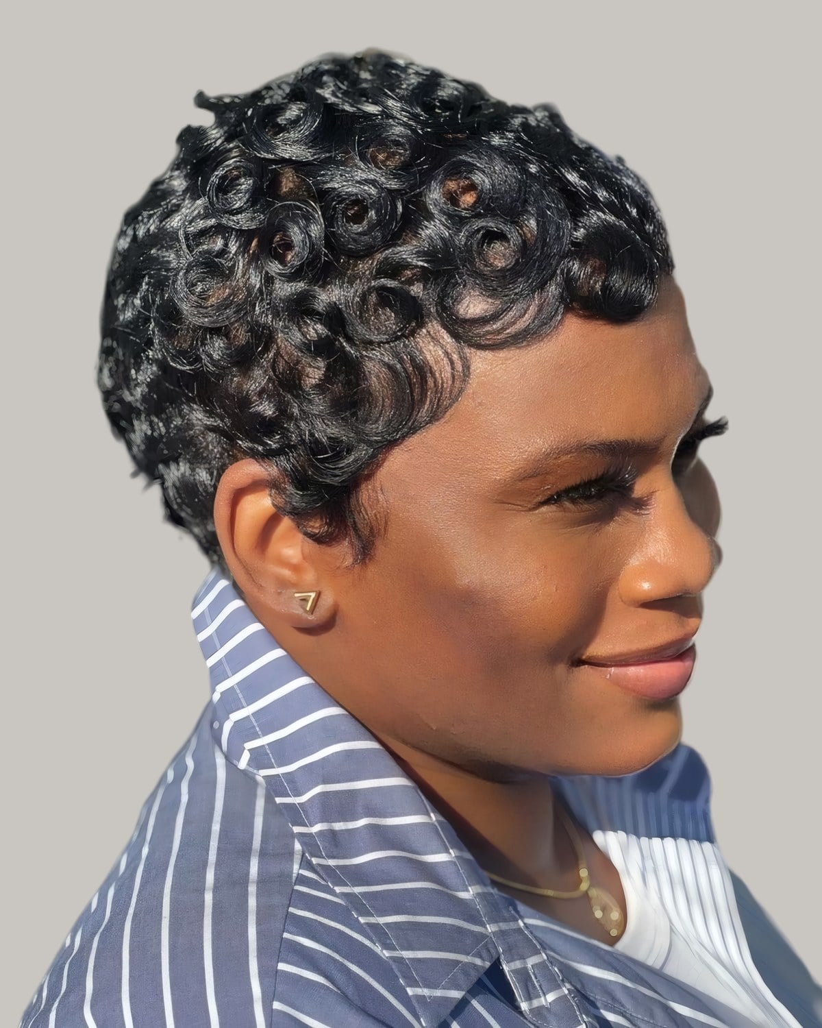 Woman with grey-black pin curls, seen from the side