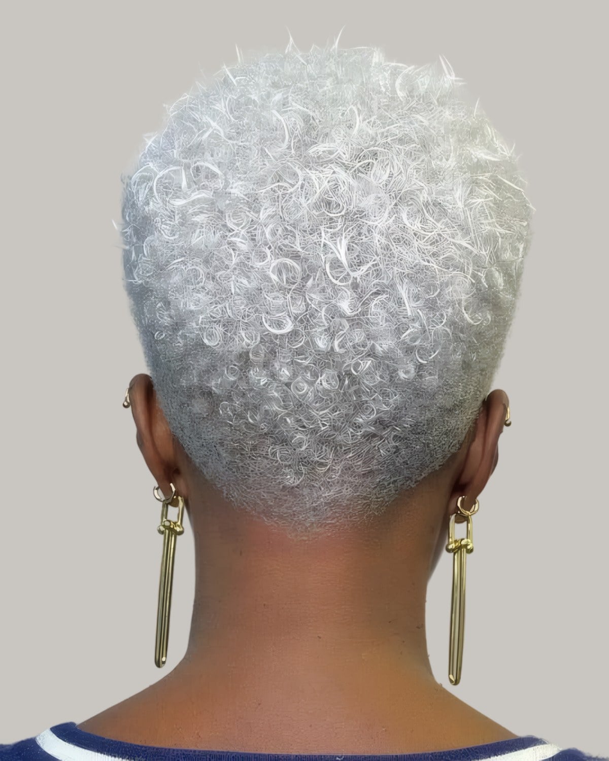 Woman with a short silver TWA seen from behind, drop earrings