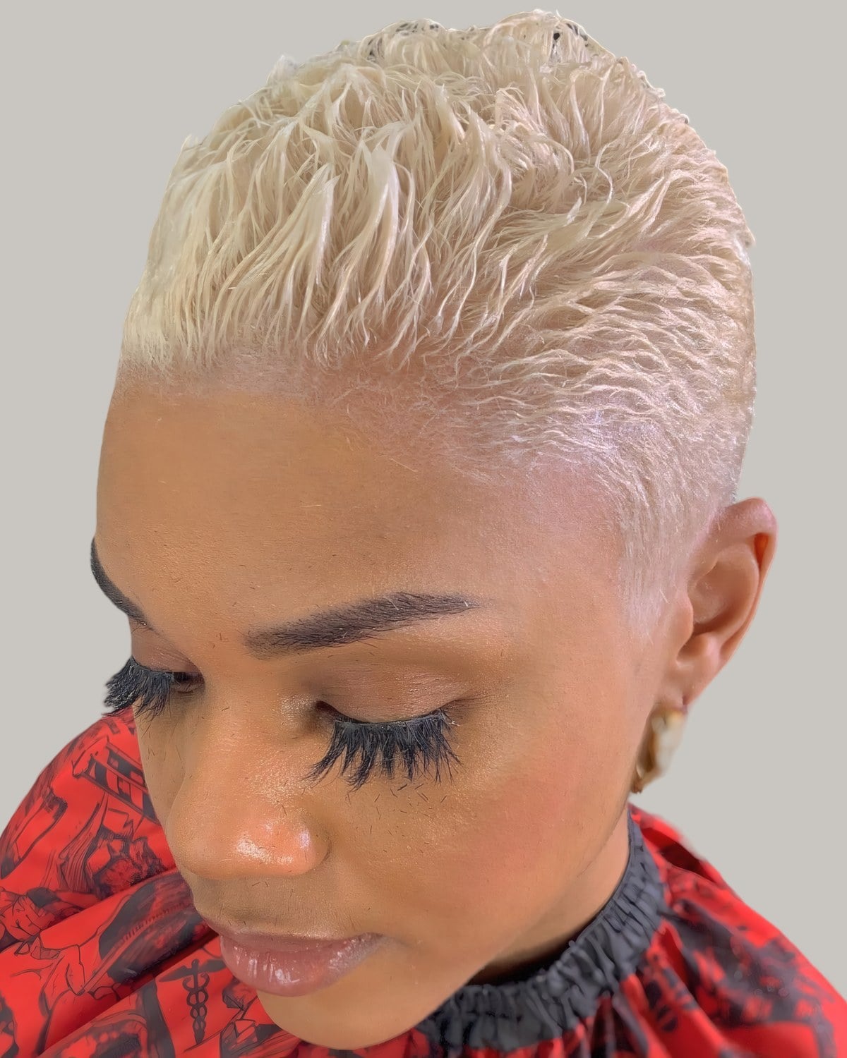 Woman with short pale blonde hair, eyes closed