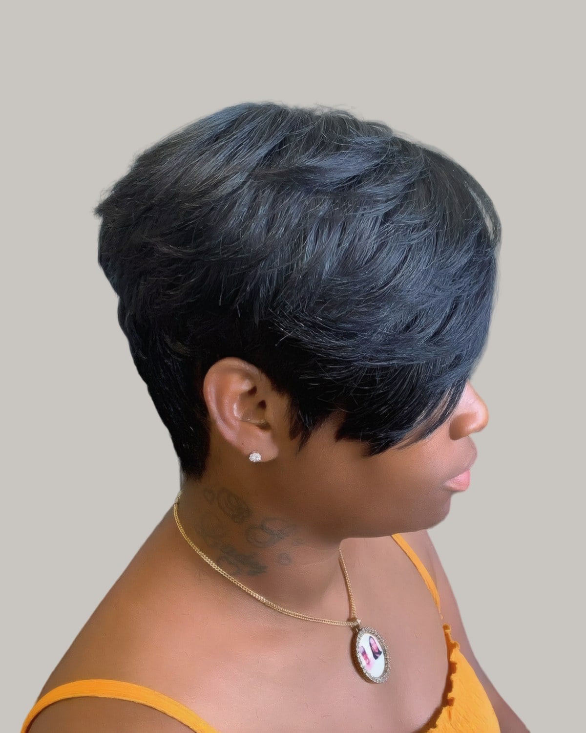 Woman with a sleek jet black short cut and a side-swept fringe