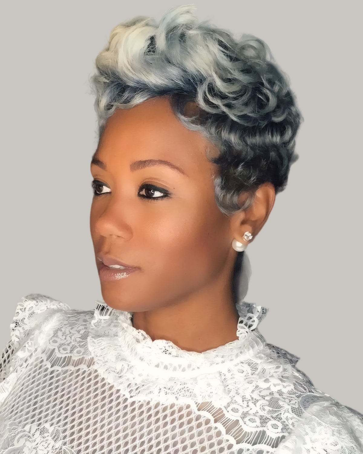 Woman with a short silver curled pixie and a lace collar