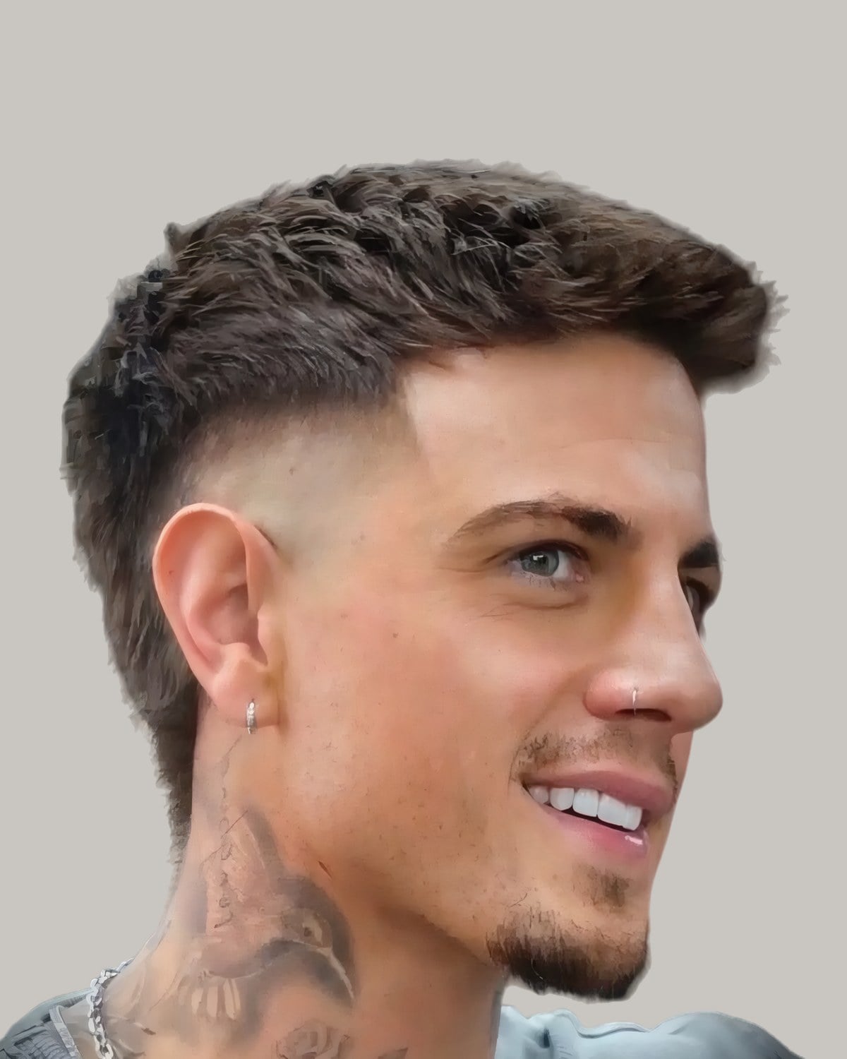 Smiling man with a textured quiff and a burst fade, seen at an angle
