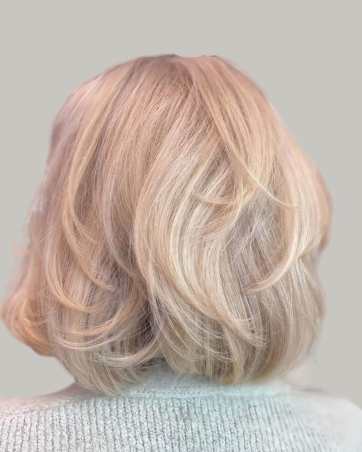 Back view of a pale blonde bob with soft, stacked layers