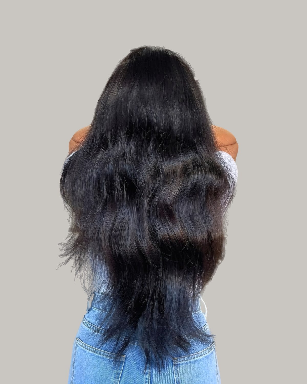 Back view of long black hair left to dry in loose waves