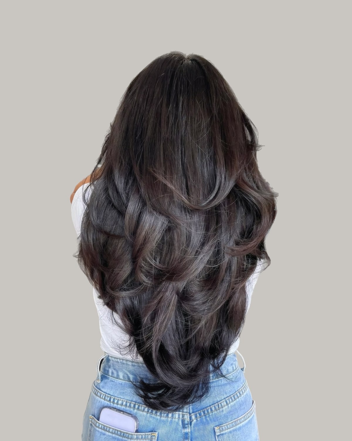 Back view of long black hair blow-dried into rounded layers
