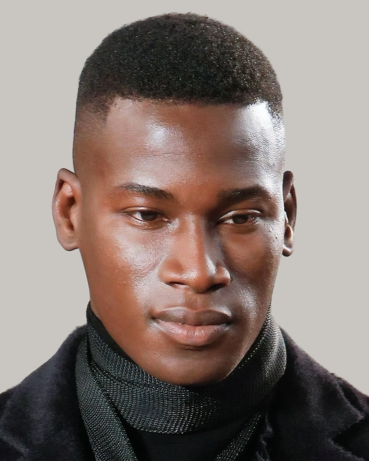 Black man with a high and tight cut, facing the camera