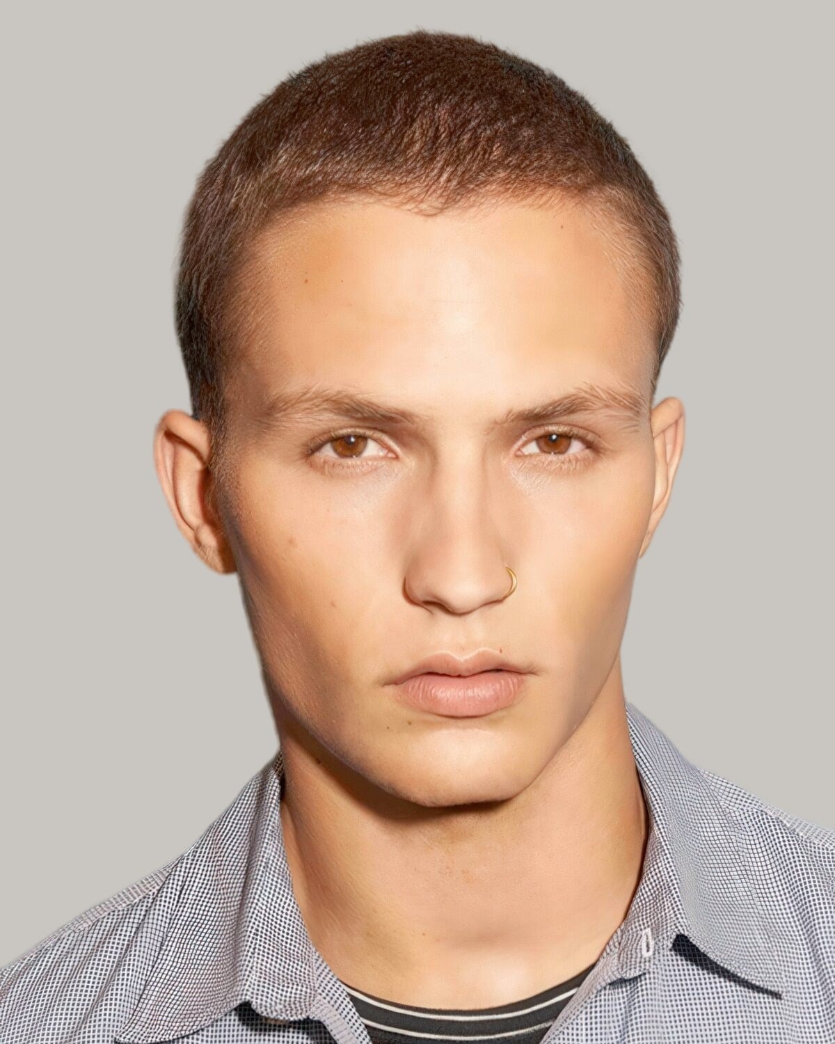 Man with a number 4 butch cut in light brown hair, facing the camera