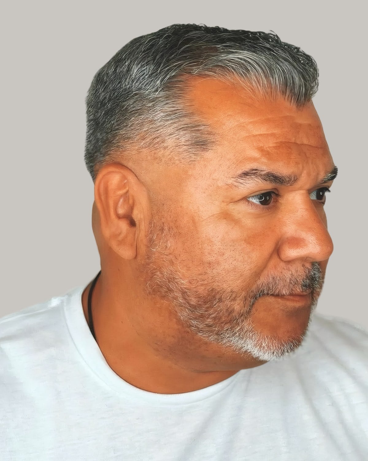 Man in his fifties with a grey buzz cut and a fade, facing the camera