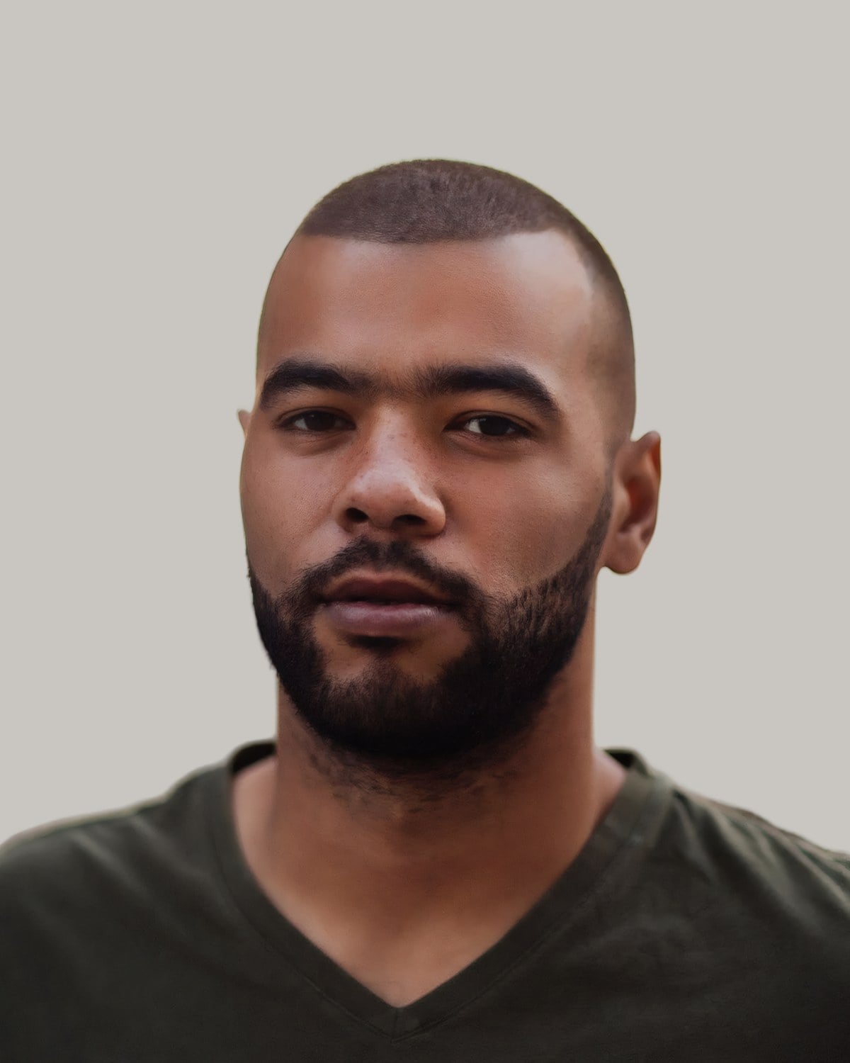 Man with a short buzz cut, a receding hairline and a beard, facing the camera