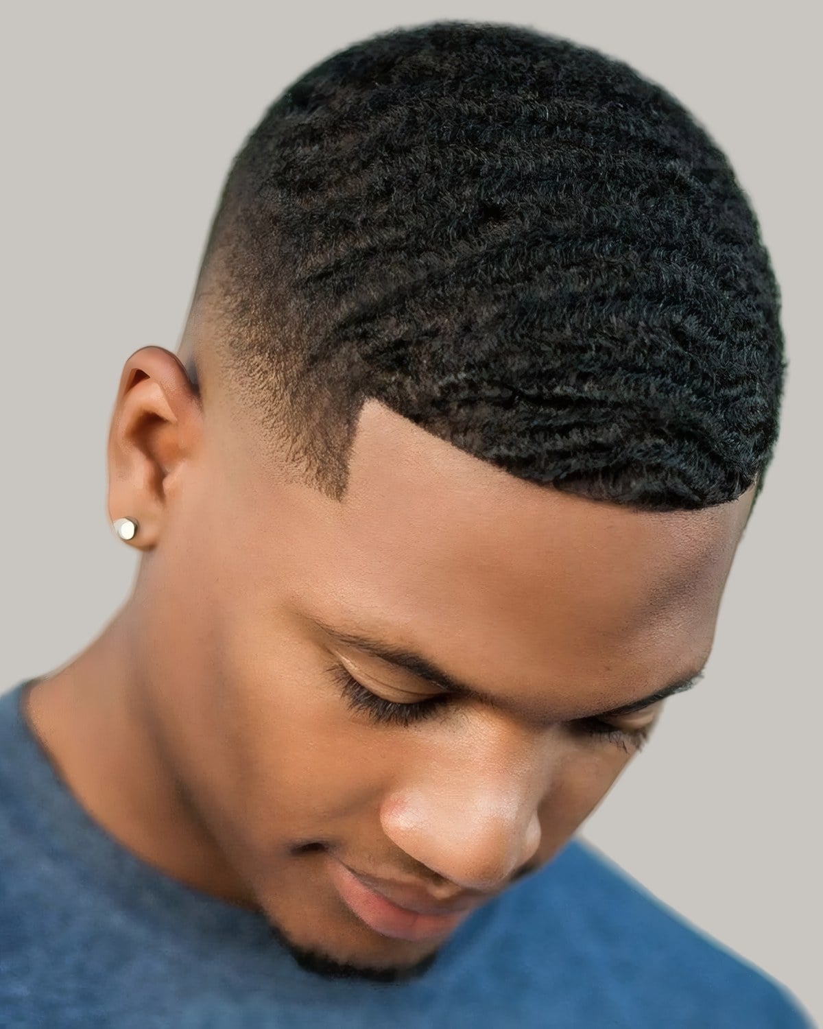 Black man with waves and a line-up, seen in profile