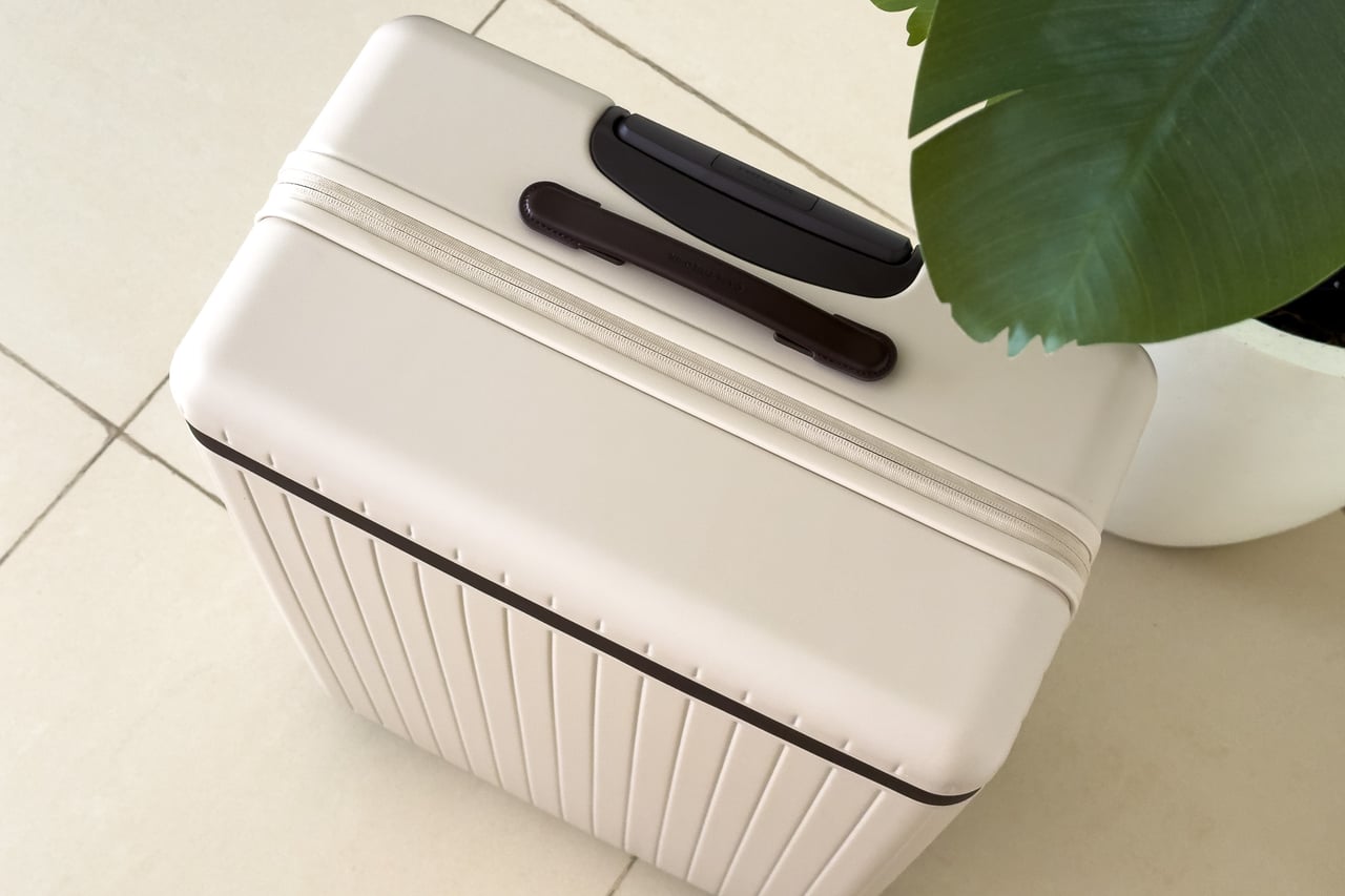 Top-down view of the Carl Friedrik suitcase with its ridged shell and leather handle - Luxe Digital
