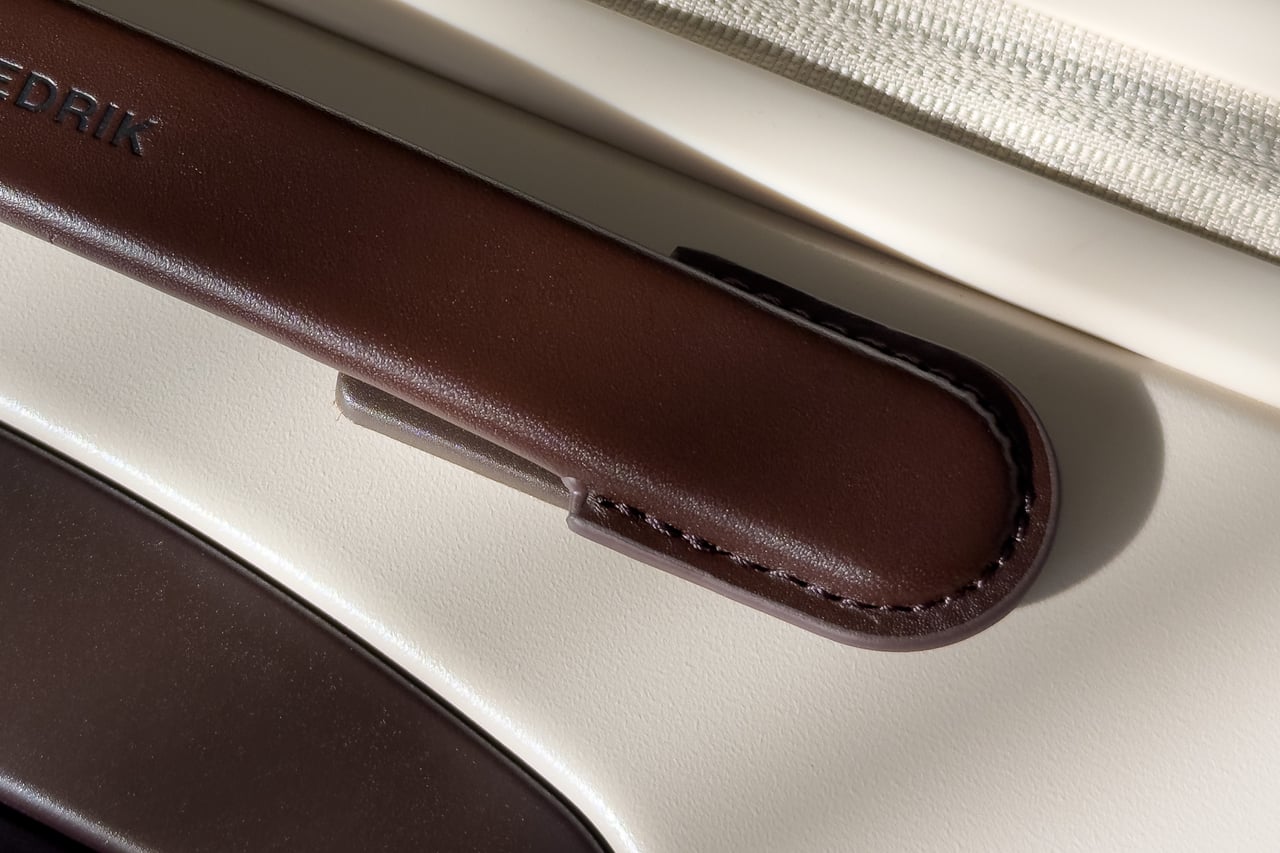 Stitched end of a Carl Friedrik leather carry handle - Luxe Digital